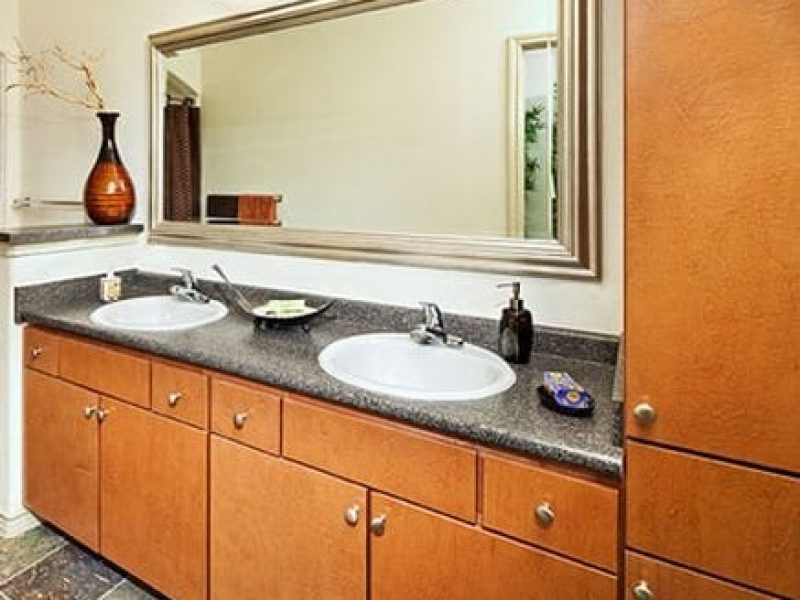This image shows the Premium Apartment Feature, especially the contemporary bath that is spacious and accessible utility. It has a sophisticated mirror and a pleasant ambiance.