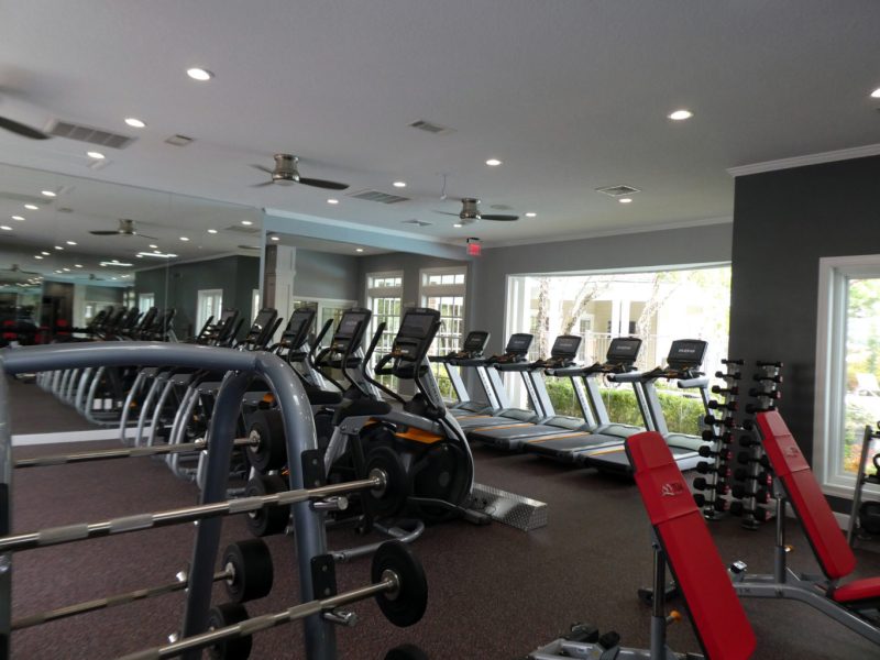 This image showcases the commercial fitness with State-of-the-art athletic club with equipment that is essential for community amenities and offering a high-quality cardio machine.