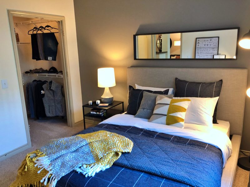 This image shows the bedroom area showcasing the light tone color wall, elegant fabrics, and an overlooking view outside that was ideal for a comfy pleasure.