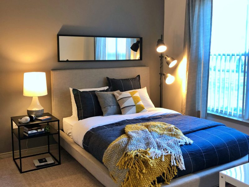 This image shows the working station inside the bedroom area featuring its pure black wall paint and fancy wall decors with a walk-in closet beside.