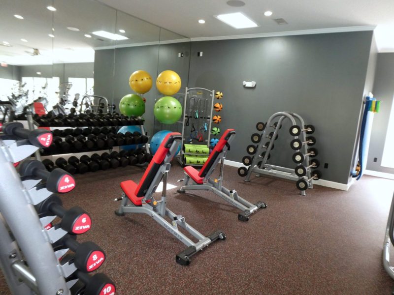 This image shows the 24-hour State-of-the-art fitness gym featuring different equipment that is essential for community amenities. The Athletic Club is also offering gym balls to test and apply proper balance.