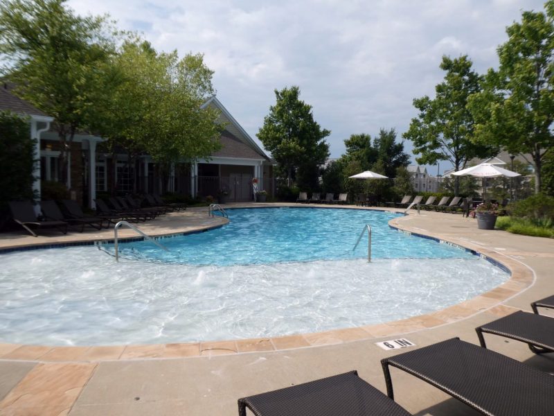 This image shows the resort-style outdoor swimming pool with a glittering sky blue water that was admirable for the fun bond with friends and family.