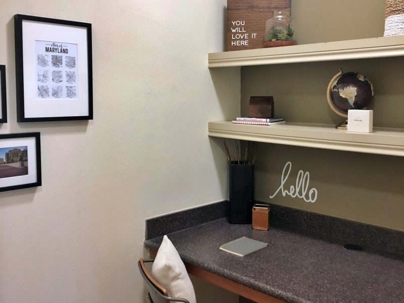 This image shows the Premium Apartment Feature, particularly the working station inside the living room area featuring itslight tone wall paint and fancy wall decors.